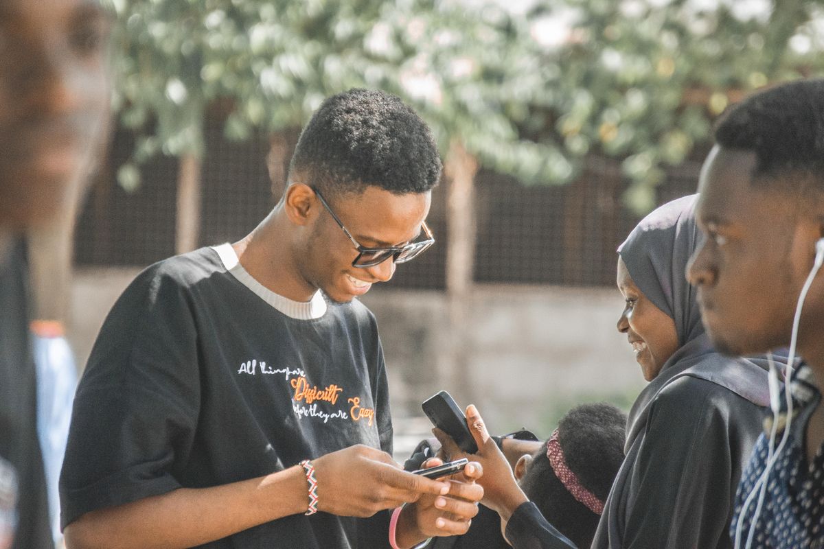 Young Tanzanians using mobile phones together